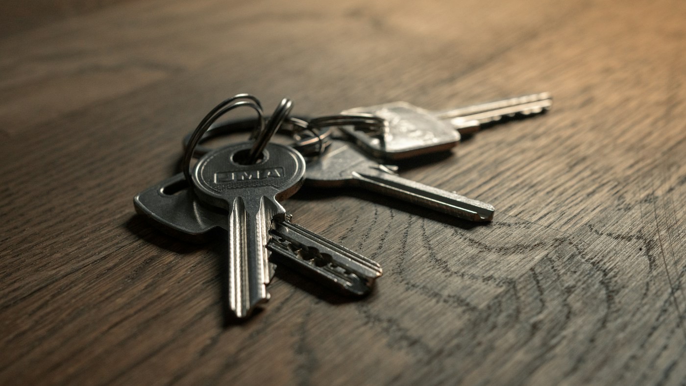 A set of house keys on a wooden table
